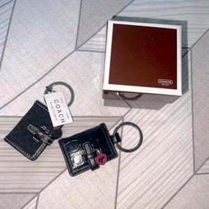 Two Coach black KeyChains in the shape of wallets